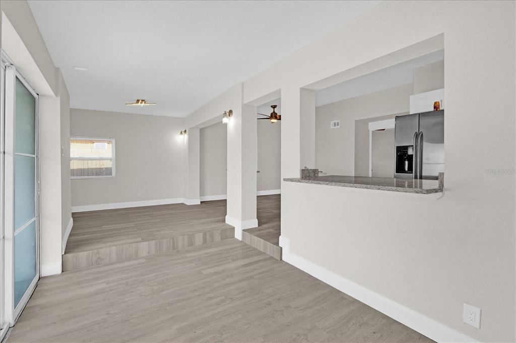 923 Ferndell Road Orlando, FL 32808 - Photo 2 of 42 a view of a big room with closet and wooden floor