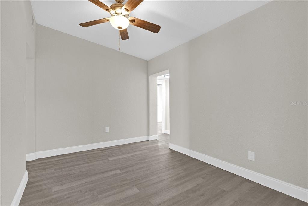 923 Ferndell Road Orlando, FL 32808 - Photo 21 of 42 a view of an empty room with window and wooden floor