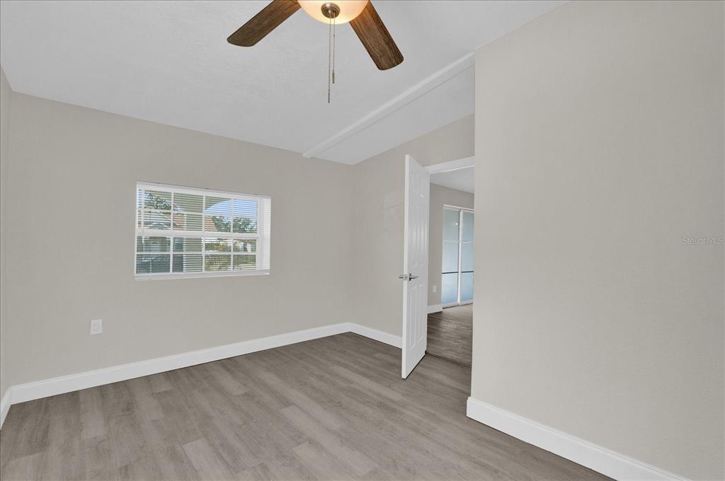 923 Ferndell Road Orlando, FL 32808 - Photo 24 of 42 an empty room with wooden floor and ceiling fan