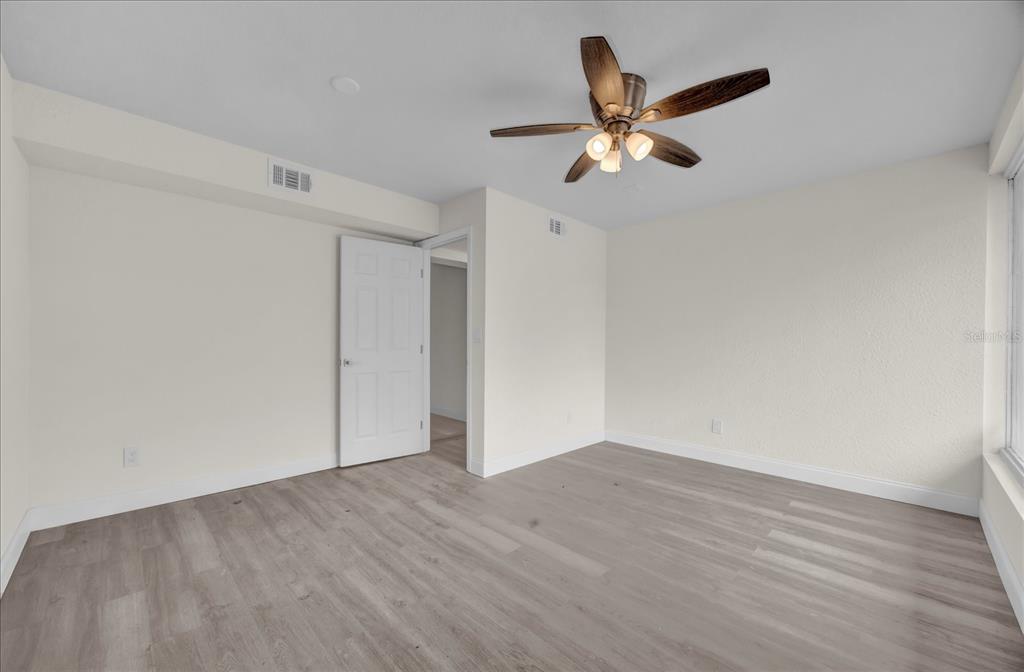 923 Ferndell Road Orlando, FL 32808 - Photo 26 of 42 a view of an empty room with wooden floor