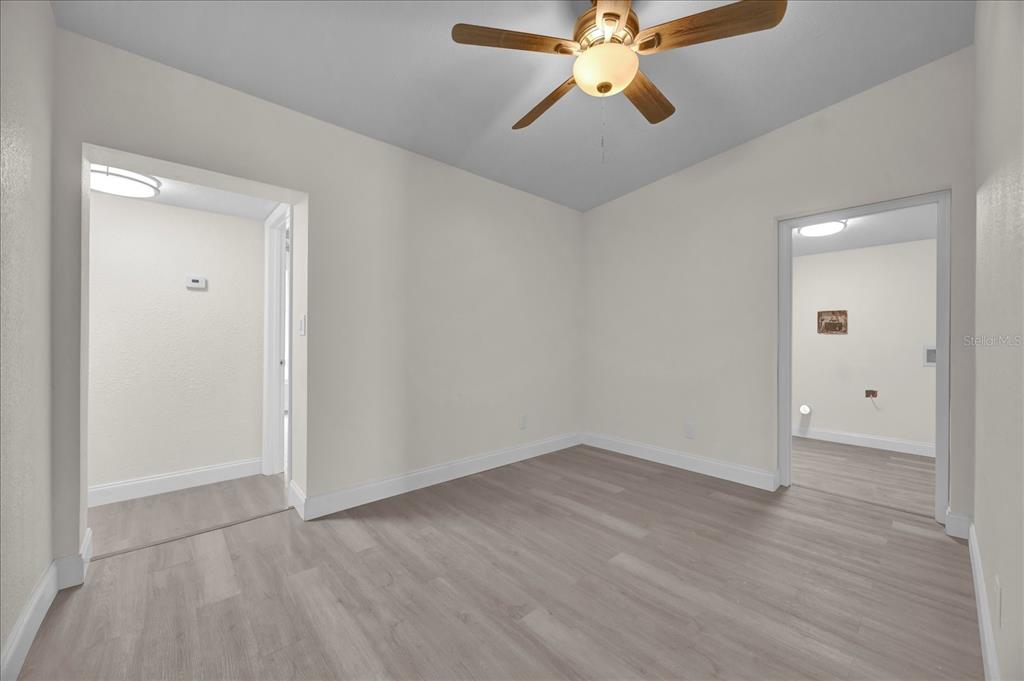 923 Ferndell Road Orlando, FL 32808 - Photo 29 of 42 an empty room with wooden floor closet and windows