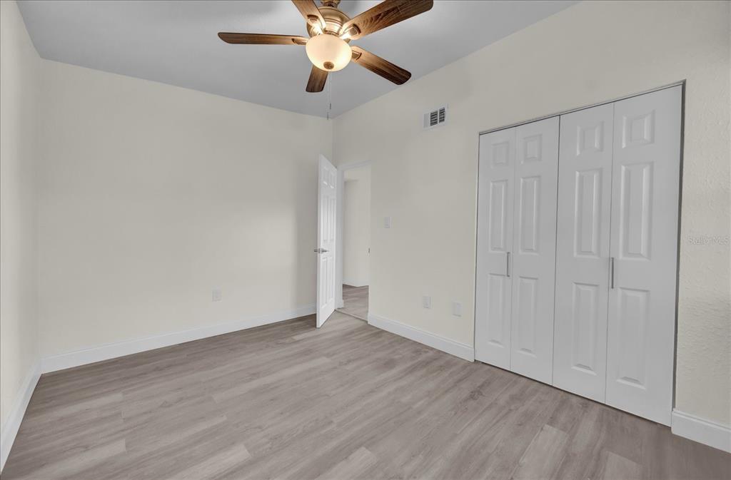 923 Ferndell Road Orlando, FL 32808 - Photo 31 of 42 a view of an empty room with wooden floor