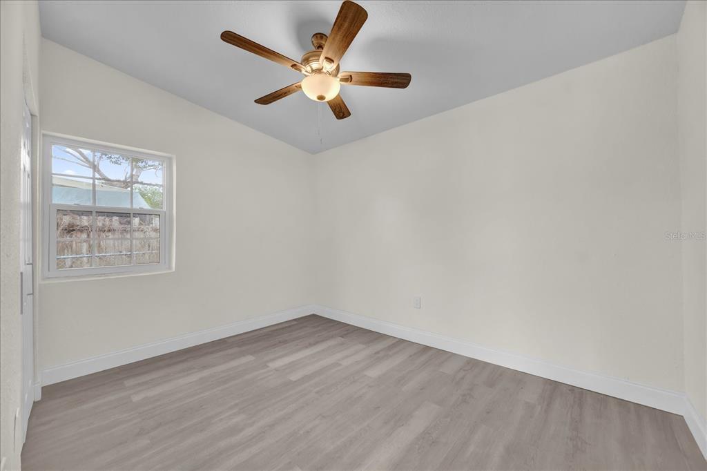 923 Ferndell Road Orlando, FL 32808 - Photo 32 of 42 an empty room with a window and a fan