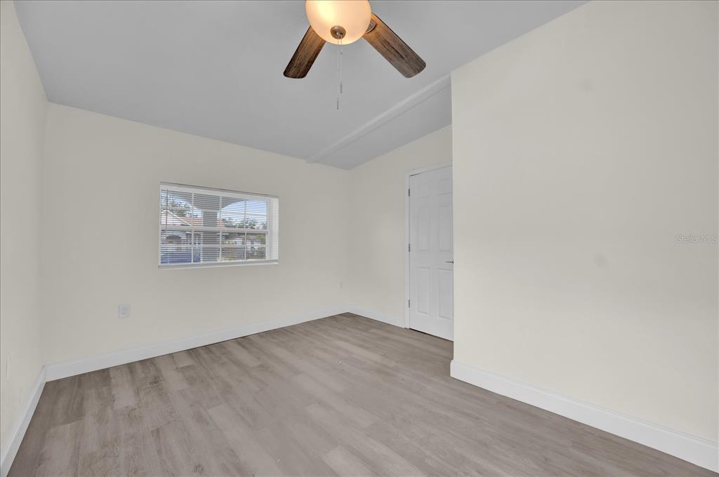 923 Ferndell Road Orlando, FL 32808 - Photo 35 of 42 an empty room with a ceiling fan and wooden floor