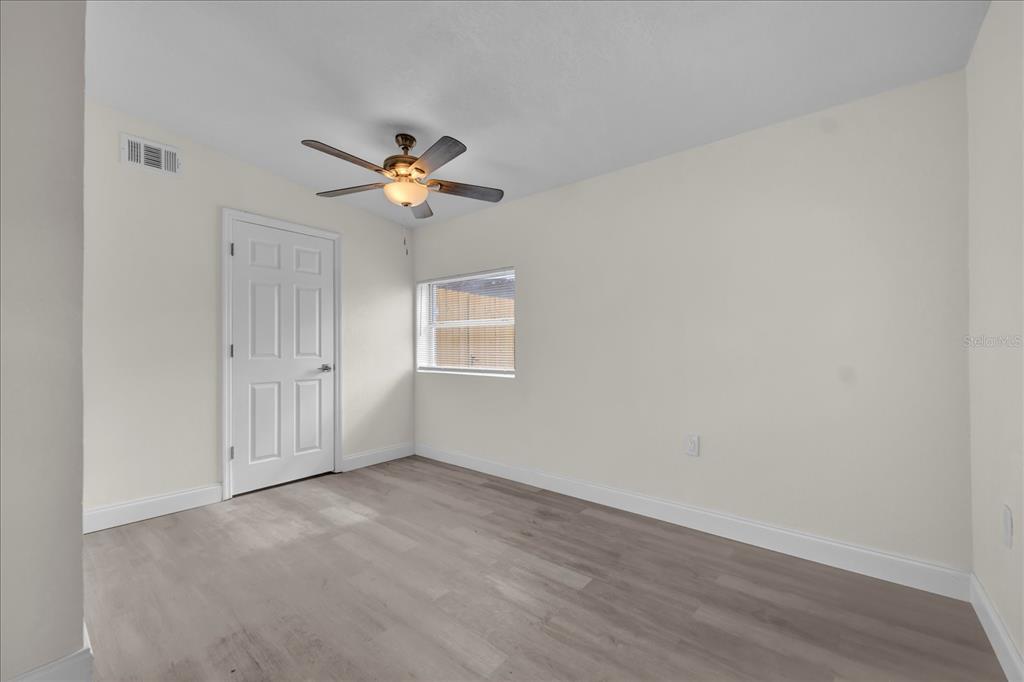 923 Ferndell Road Orlando, FL 32808 - Photo 36 of 42 a view of a room with a ceiling fan and a window