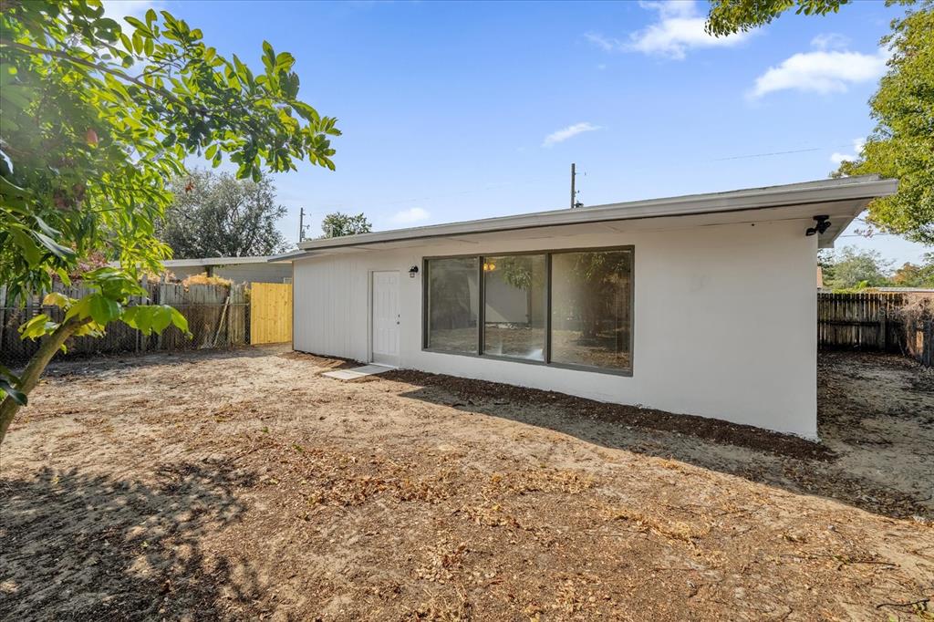 923 Ferndell Road Orlando, FL 32808 - Photo 37 of 42 a view of a house with a yard and potted plants