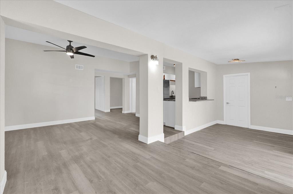923 Ferndell Road Orlando, FL 32808 - Photo 6 of 42 wooden floor in an empty room with a window