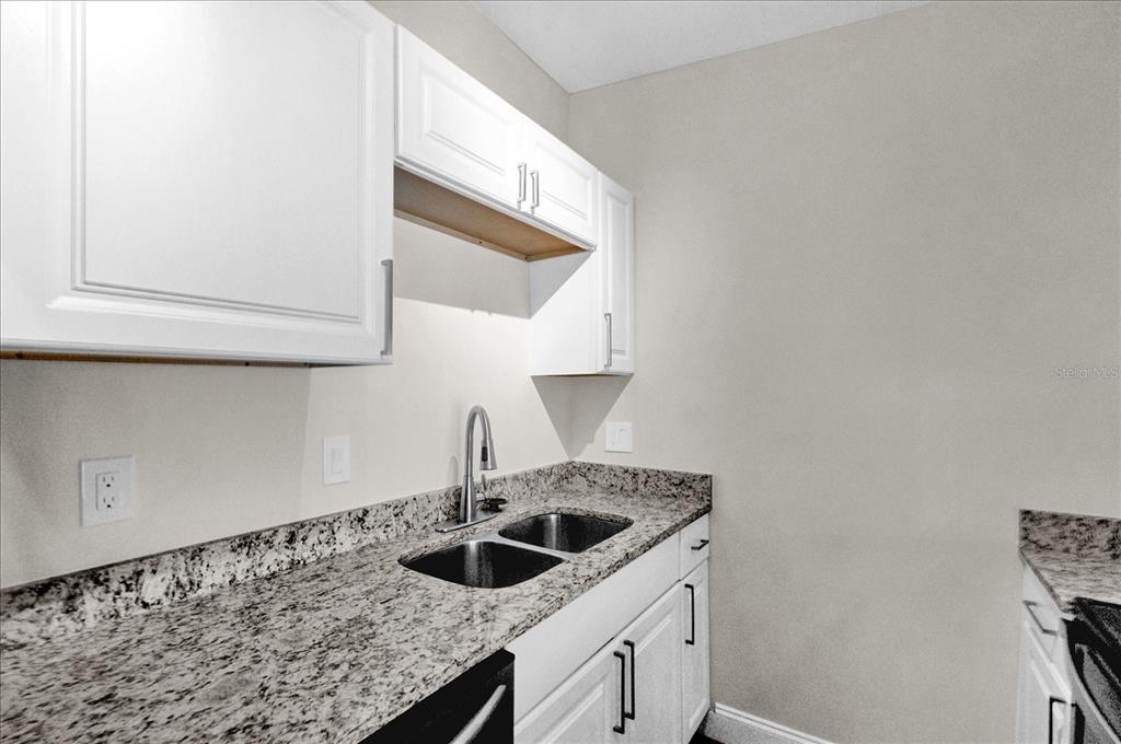 923 Ferndell Road Orlando, FL 32808 - Photo 10 of 42 a kitchen with a sink and cabinets