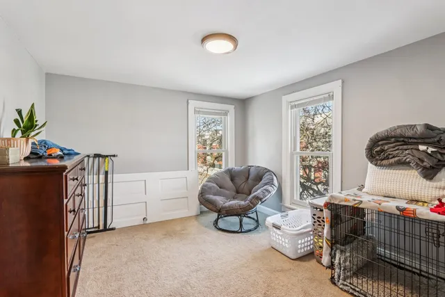 a bedroom with furniture and a window