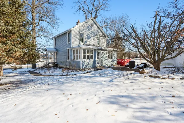 a view of a house with a snow in the yard