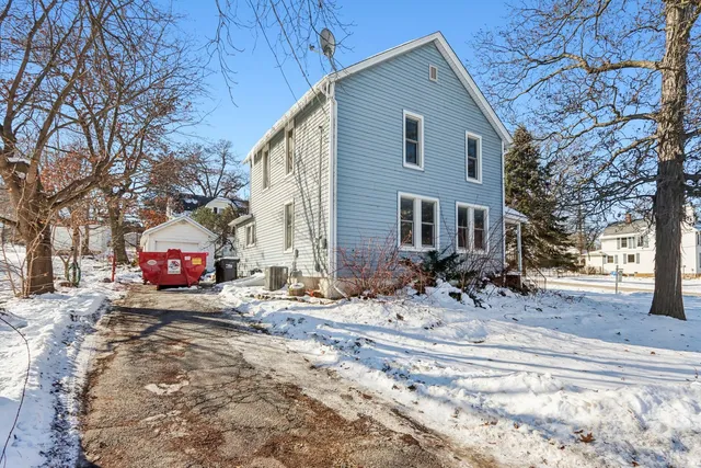 a front view of a house with yard covered in snow