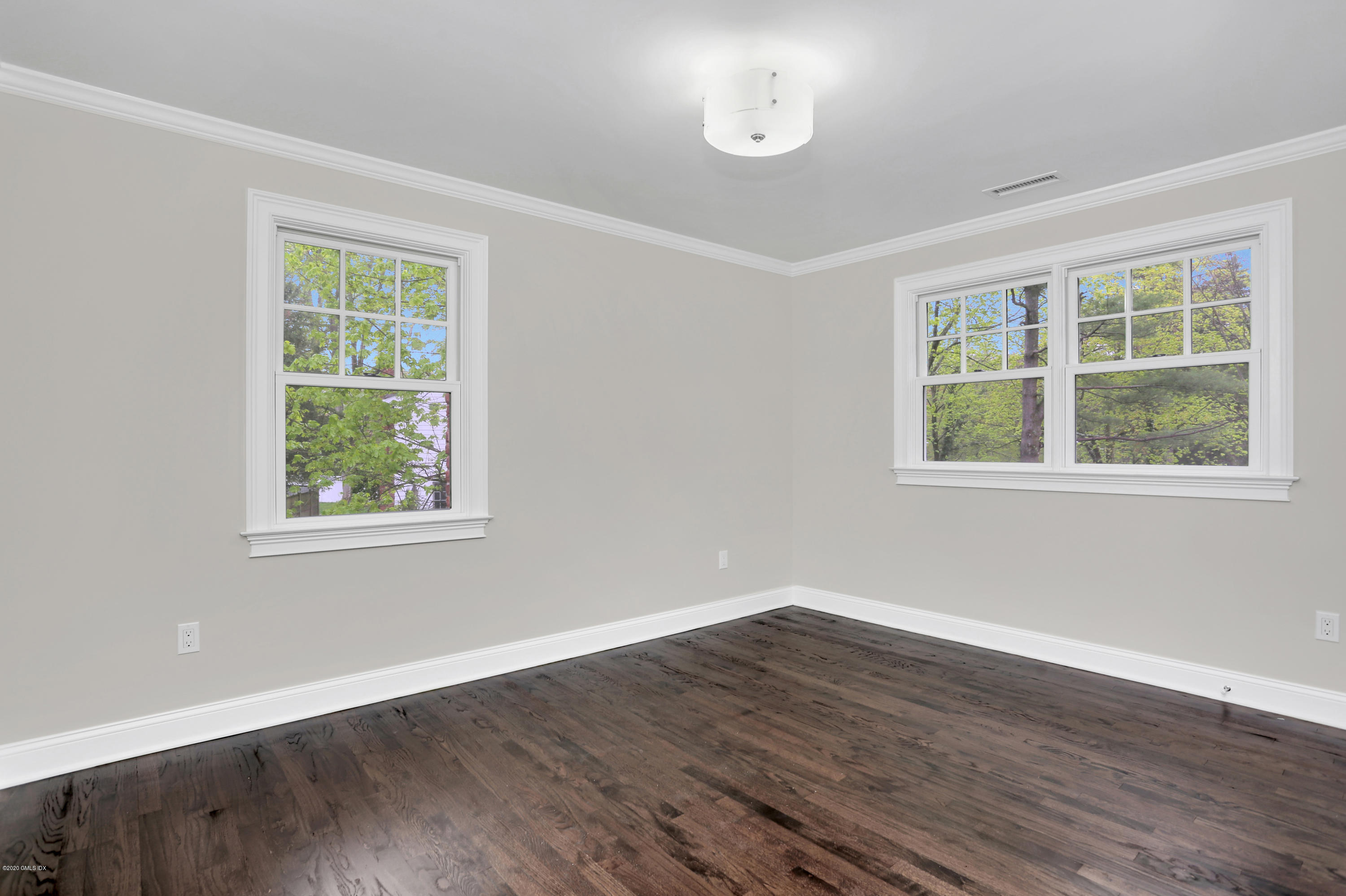 183 North Maple Avenue Greenwich, CT 06830 - Photo 13 of 26 a view of an empty room with wooden floor and a window