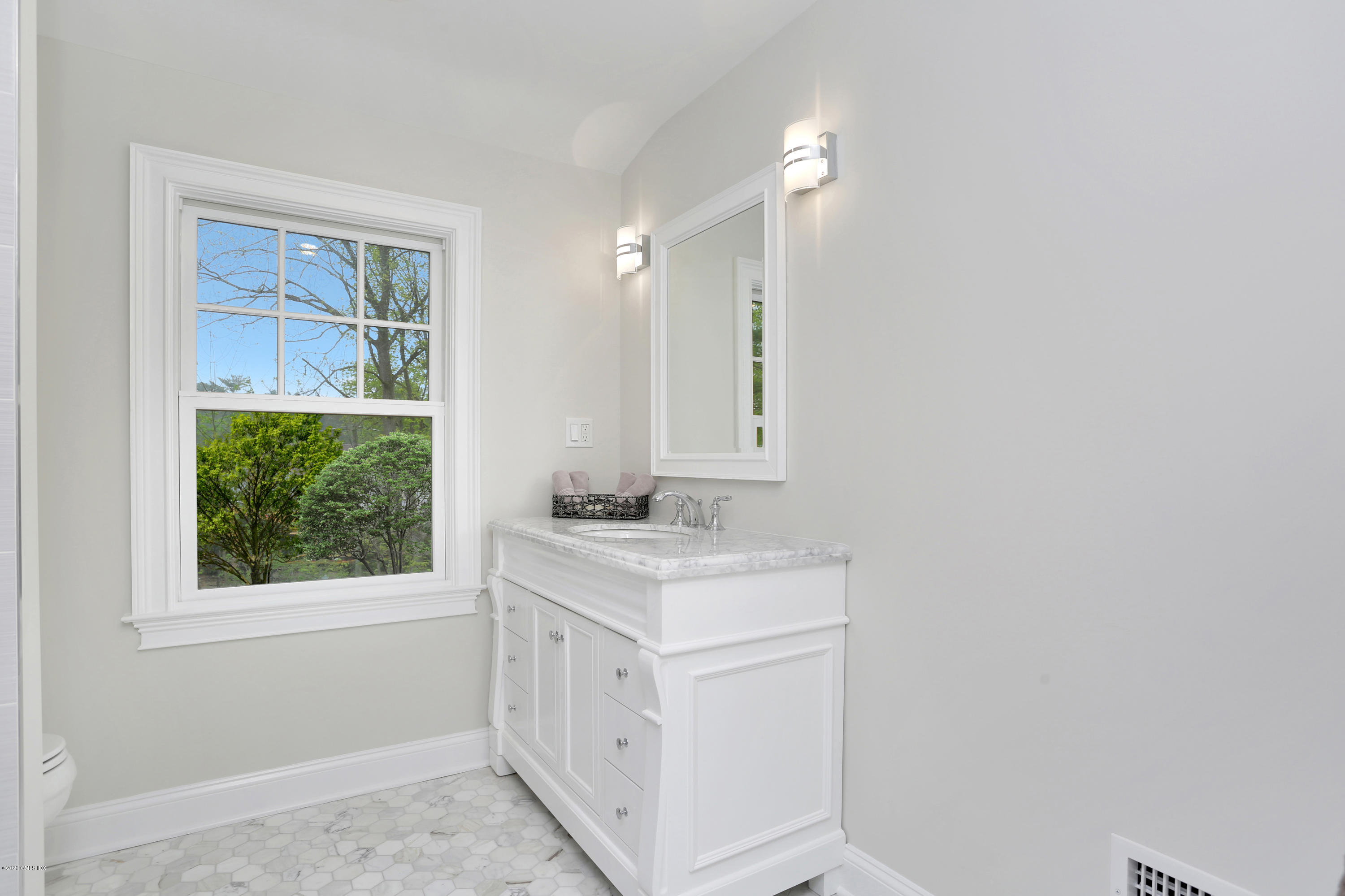 183 North Maple Avenue Greenwich, CT 06830 - Photo 14 of 26 a bathroom with a sink a vanity and a mirror