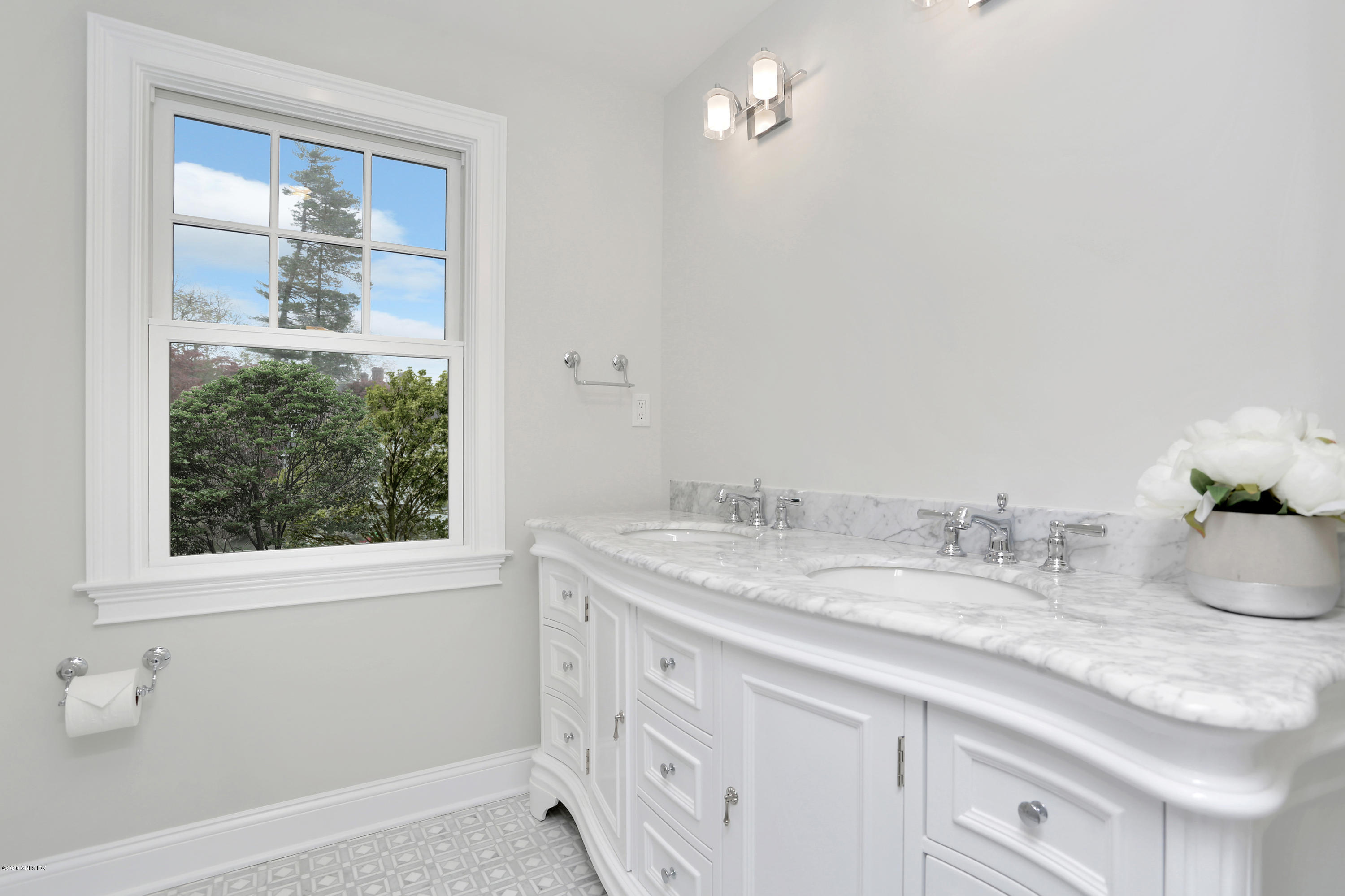 183 North Maple Avenue Greenwich, CT 06830 - Photo 16 of 26 a bathroom with a granite countertop sink a large mirror and a window