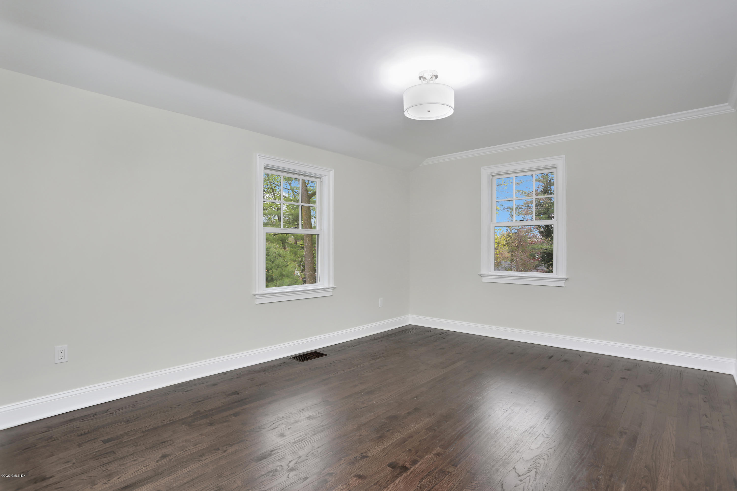 183 North Maple Avenue Greenwich, CT 06830 - Photo 20 of 26 a view of an empty room with wooden floor and a window