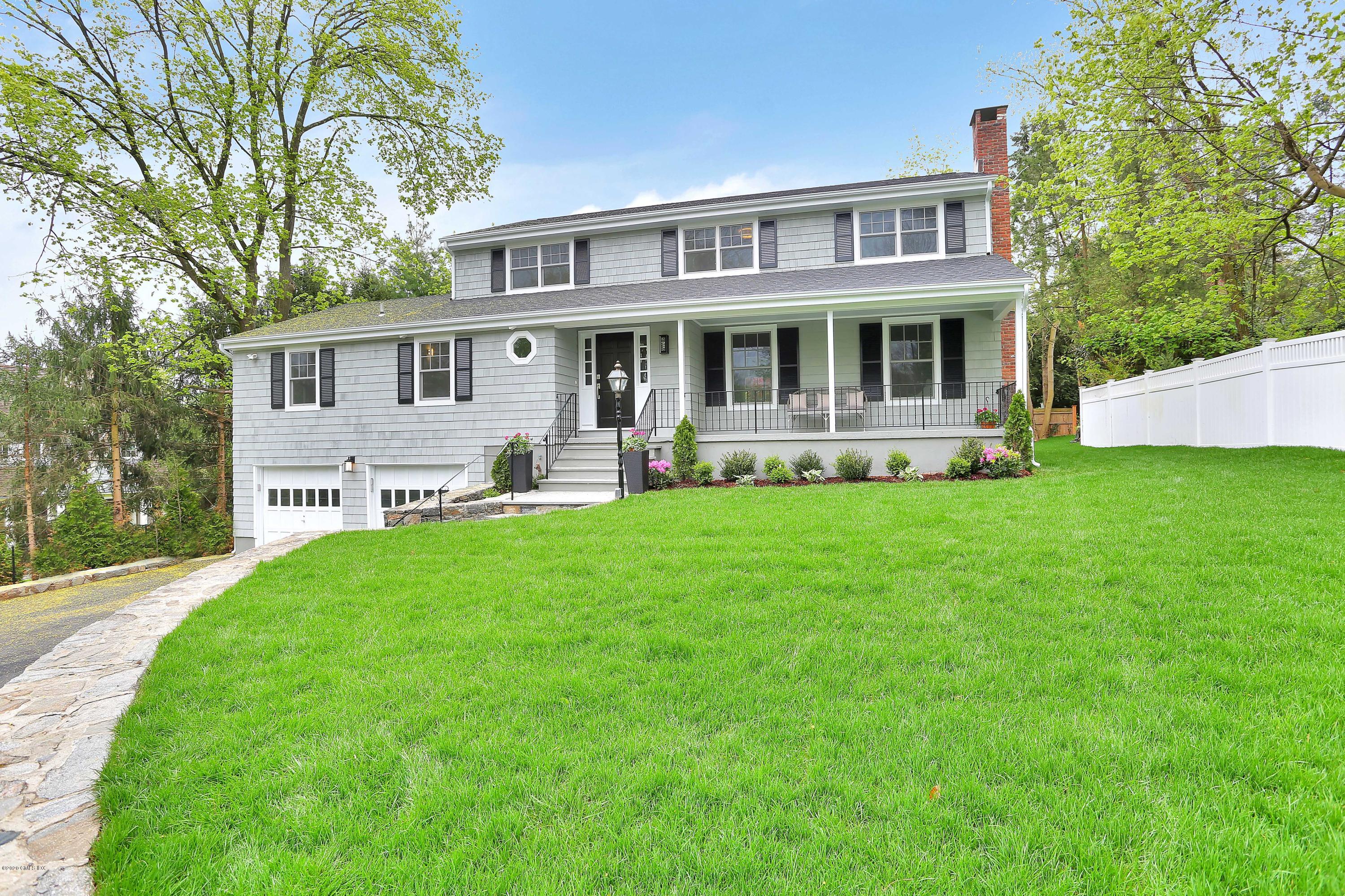 183 North Maple Avenue Greenwich, CT 06830 - Photo 2 of 26 a front view of a house with a yard table and chairs
