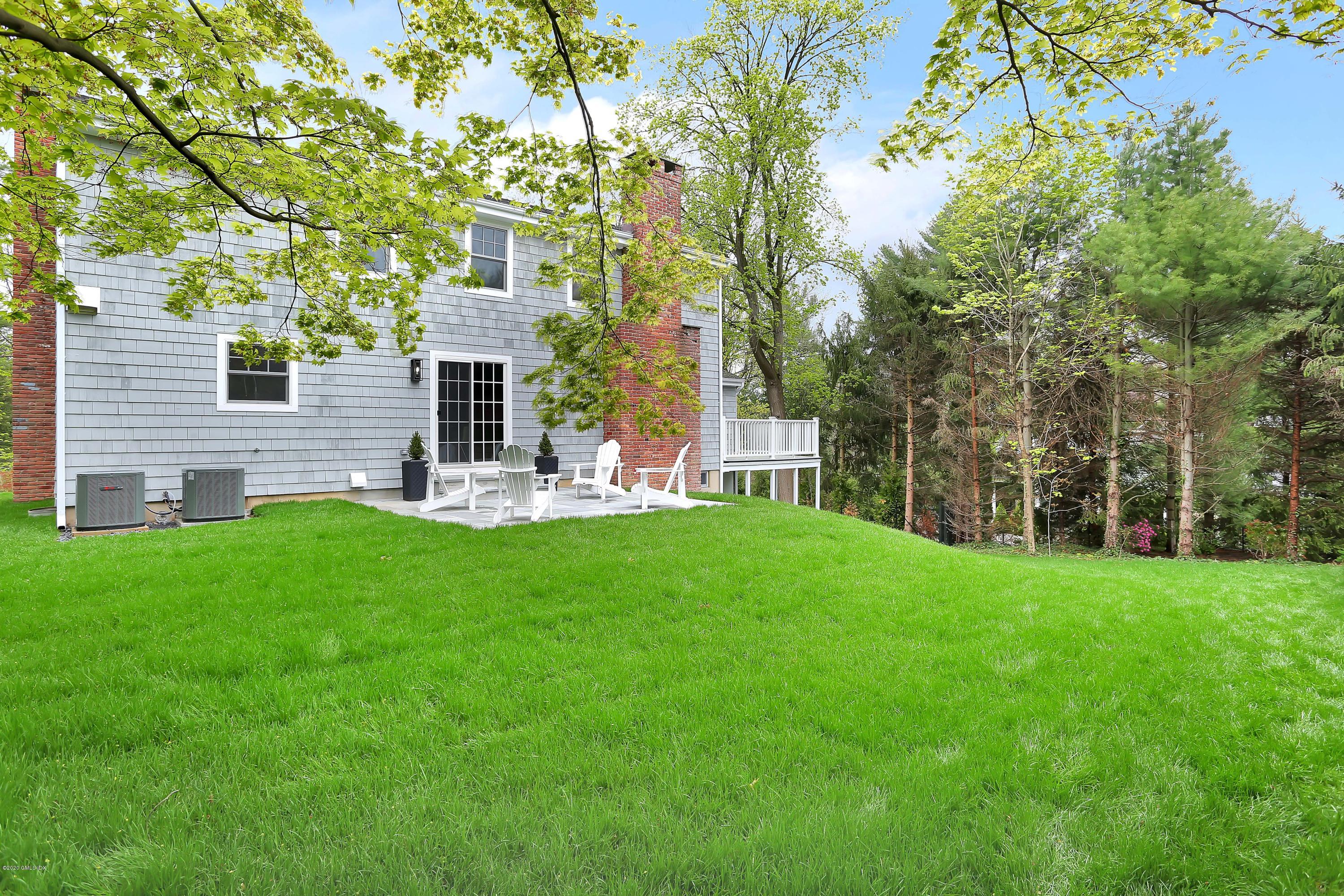 183 North Maple Avenue Greenwich, CT 06830 - Photo 22 of 26 a view of a house with a backyard