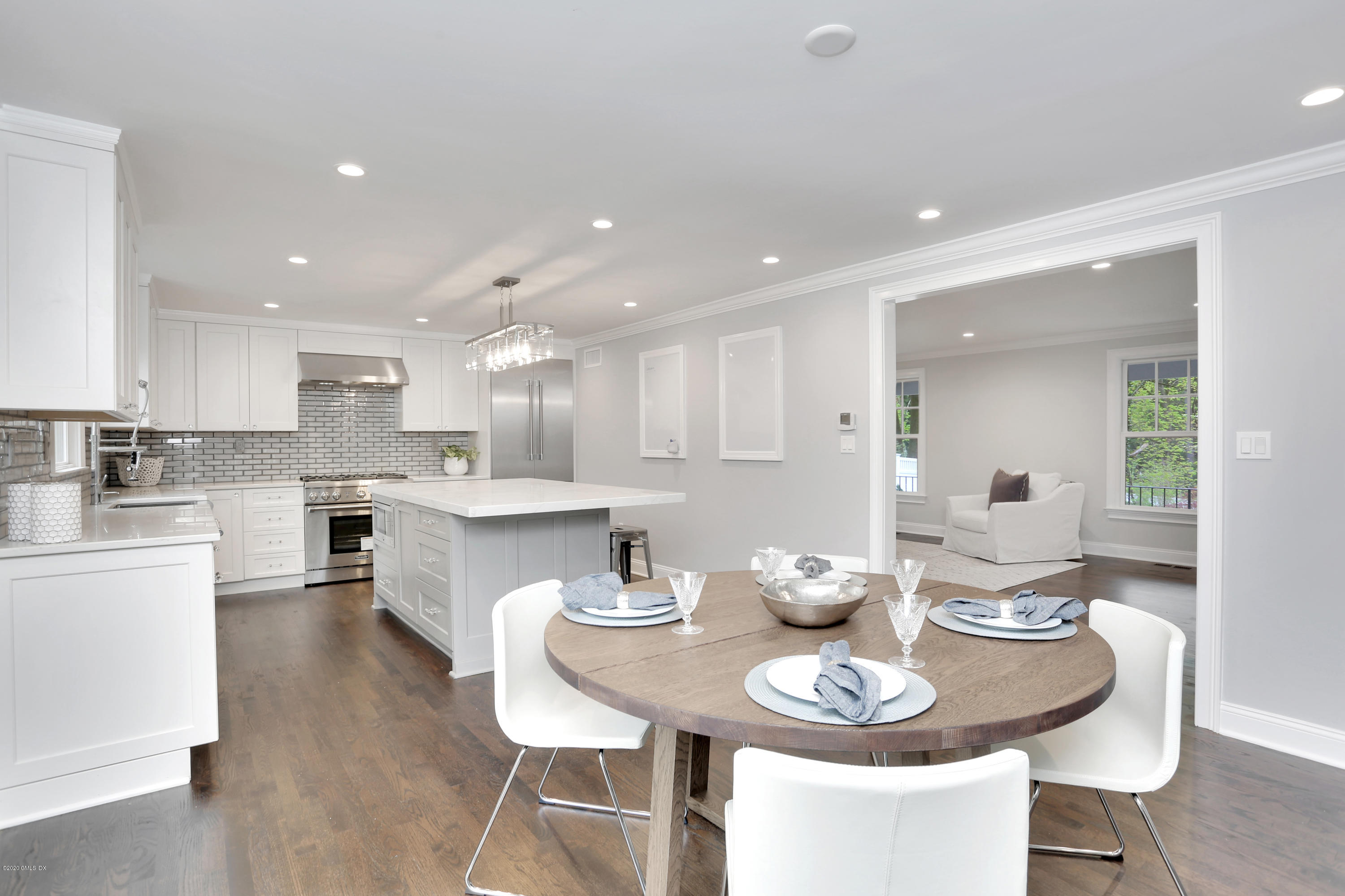 183 North Maple Avenue Greenwich, CT 06830 - Photo 6 of 26 a kitchen with granite countertop a white table and chairs in it