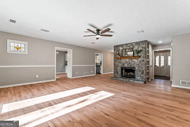a view of a livingroom with a fireplace and a workspace