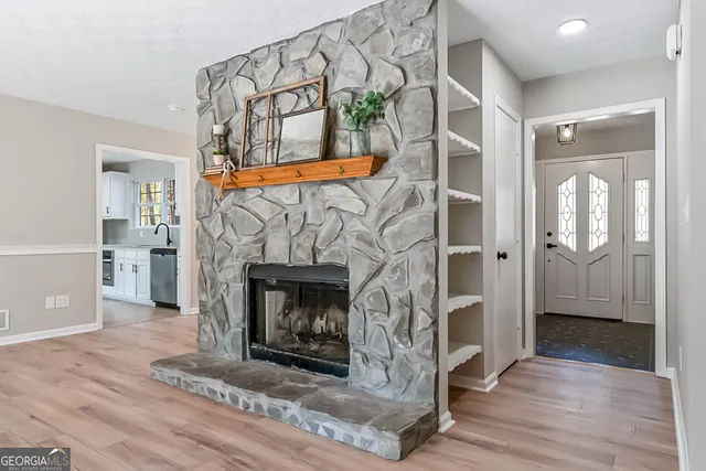 a view of an empty room and fire place