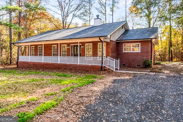 a front view of a house with a yard and outdoor seating