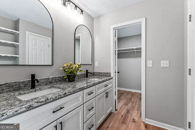 a kitchen with cabinets appliances and a wooden floor
