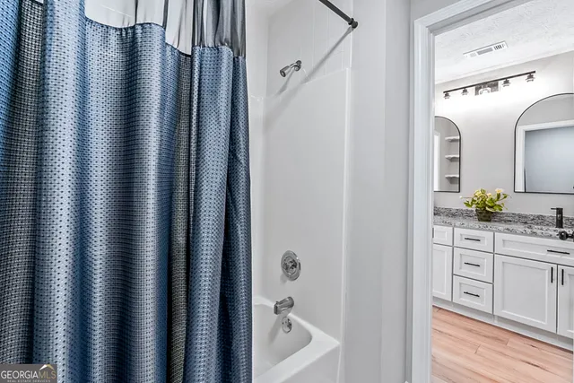 a bathroom with a bathtub and shower