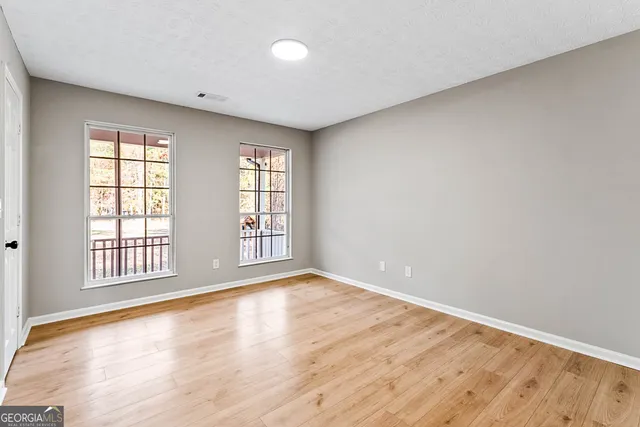 wooden floor in an empty room with a window