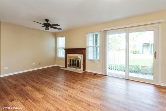 948 Ridgefield Lane Wheeling, IL 60090 - Photo 2 of 10 a view of empty room with wooden floor and fan