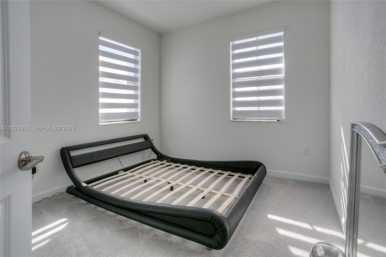 12911 Southwest 231st Terrace Miami, FL 33170 - Photo 14 of 15 a bedroom with a bed and a window