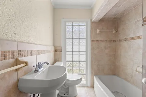 a bathroom with a sink toilet and a mirror