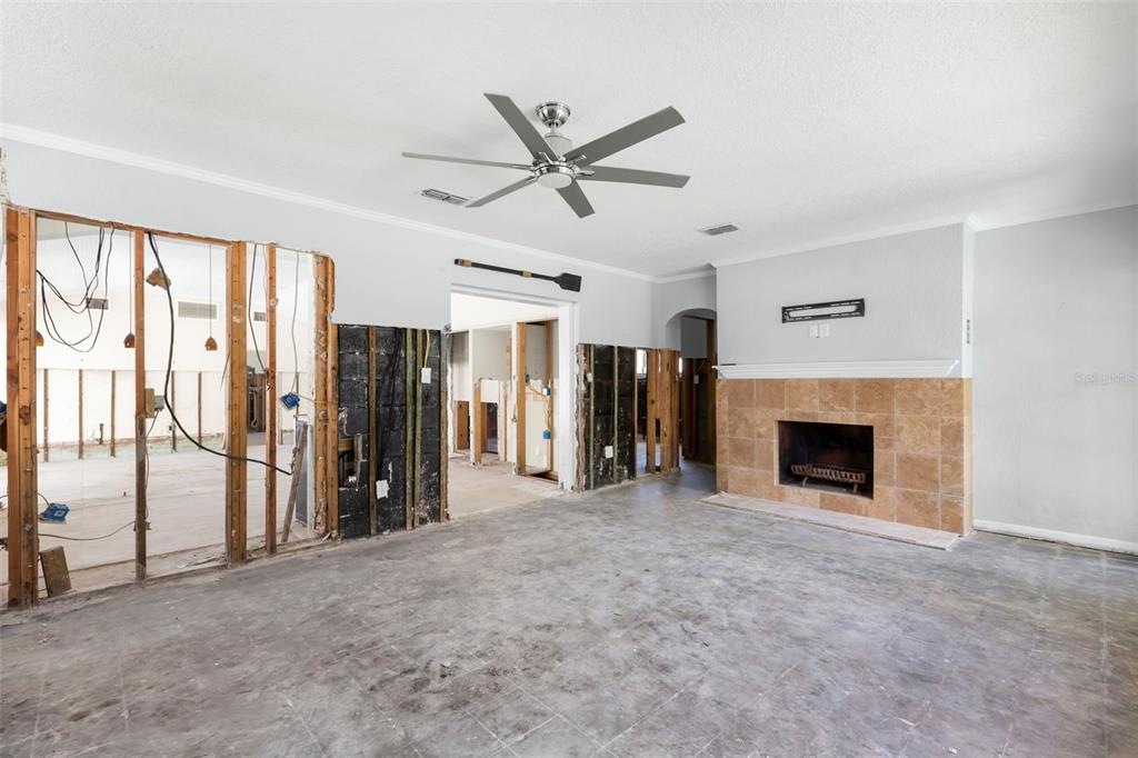 106 13th Avenue St. Pete Beach, FL 33706 - Photo 7 of 41 a view of a livingroom with a fireplace and a ceiling fan