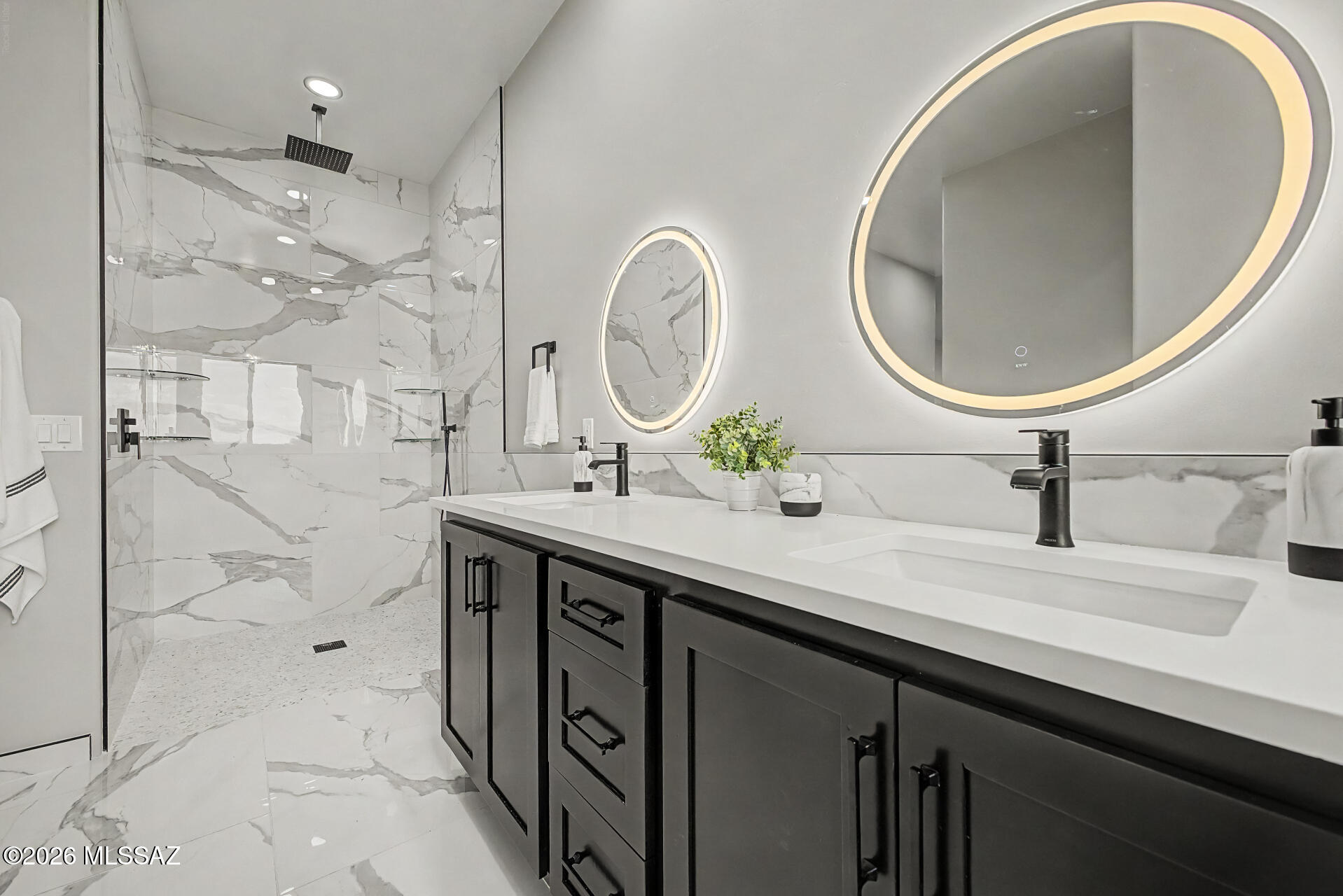 2399 Della Roccia Court Tucson, AZ 85737 - Photo 18 of 34 a bathroom with a double vanity sink mirror and a shower