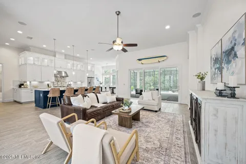 a kitchen with stainless steel appliances kitchen island granite countertop a sink a stove and white cabinets
