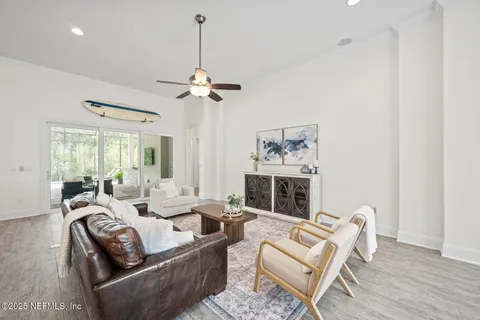 a large kitchen with stainless steel appliances a stove a sink dishwasher a oven and a dining table with wooden floor