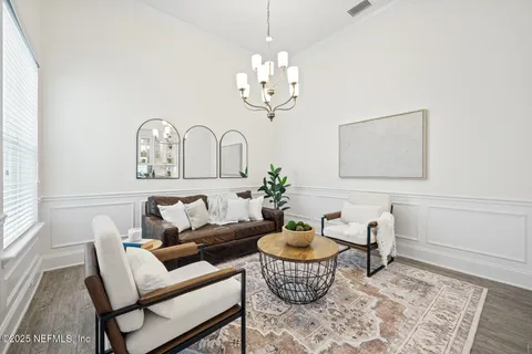 a view of a dining room with furniture window and wooden floor