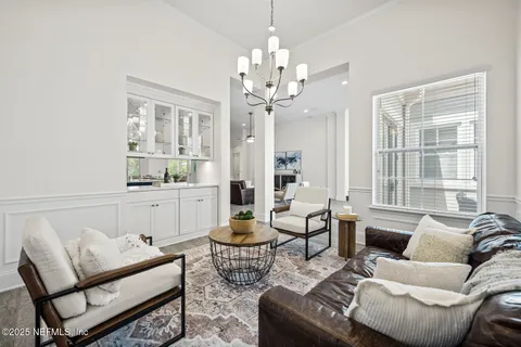 a spacious bedroom with a balcony a bed and a large window with wooden floor