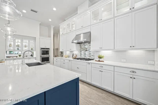a view of a hallway with wooden floor and a living room