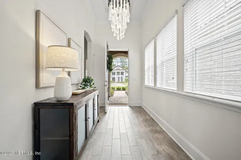 a living room with lots of furniture and a chandelier
