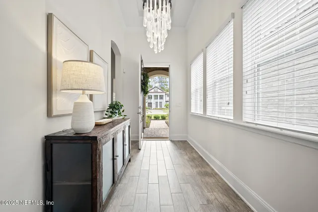 a living room with lots of furniture and a chandelier