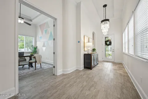 a living room with furniture a flat screen tv and a window