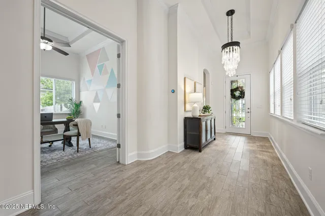a living room with furniture a flat screen tv and a window