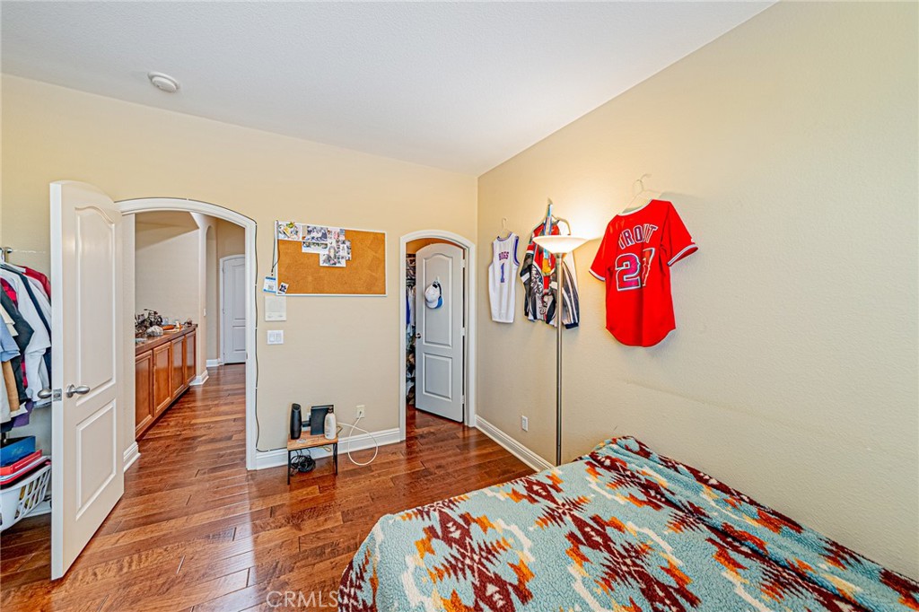 4088 Shady Ridge Circle Corona, CA 92881 - Photo 18 of 47 a bedroom with a bed and a book shelf