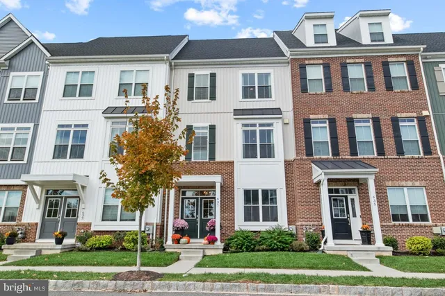 a front view of a residential apartment building with a yard