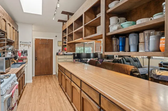 a view of a house with a barbeque and wooden floor