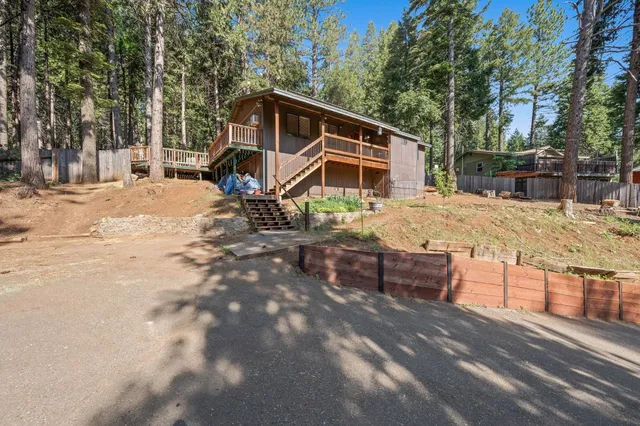 a view of a house with a yard covered in snow