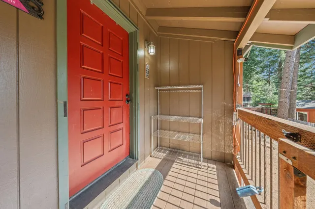 a view of a porch with wooden floor and doors