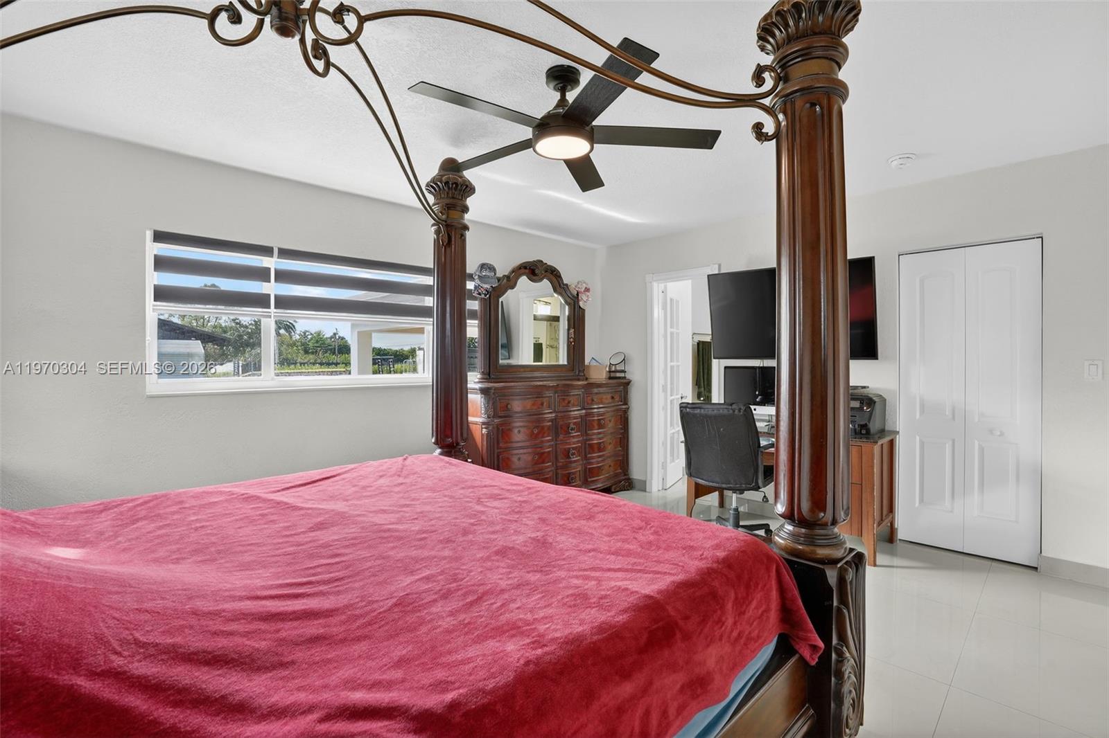 19390 Southwest 312th Street Homestead, FL 33030 - Photo 20 of 41 a bed sitting in a bedroom next to a window