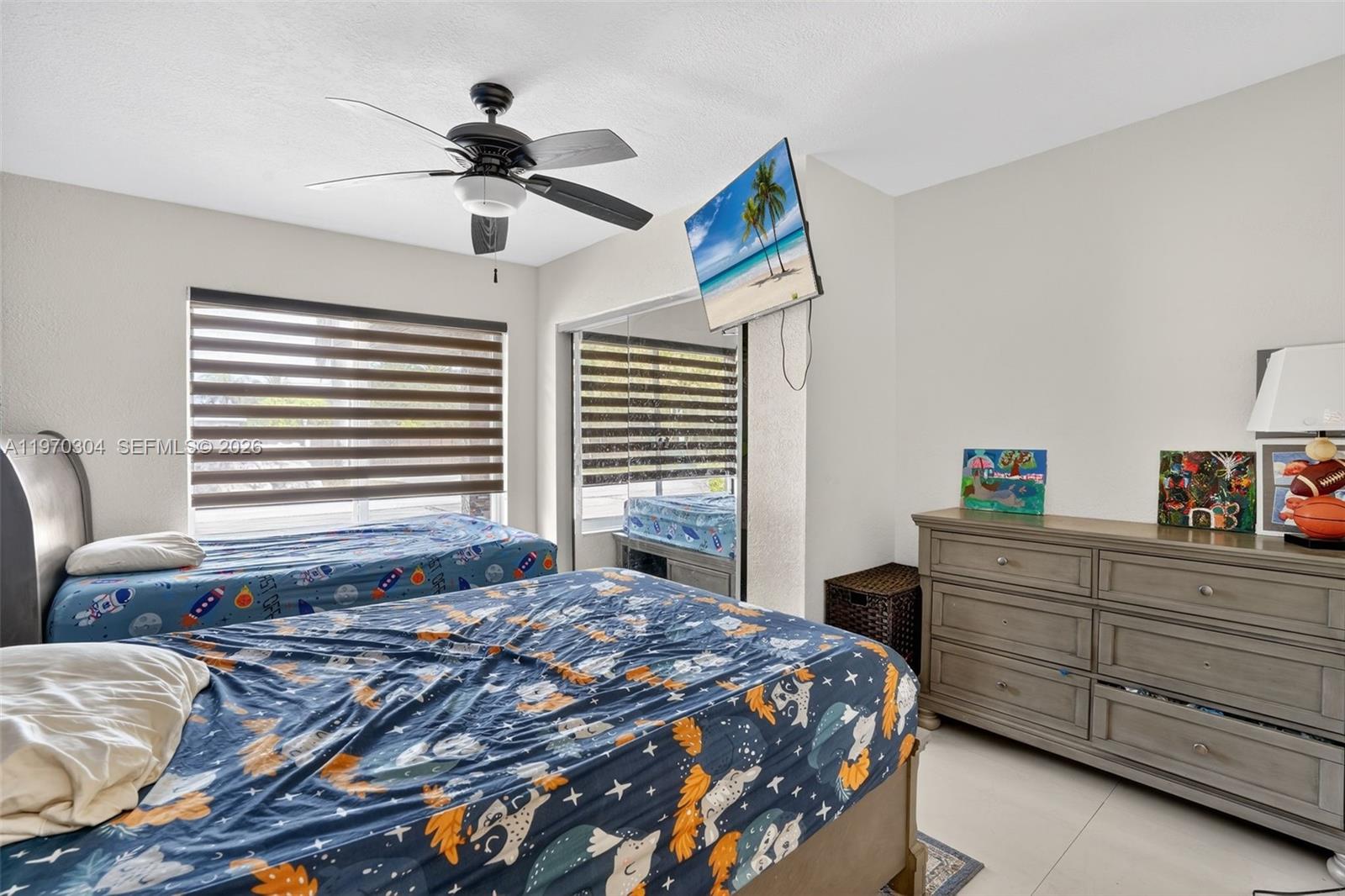 19390 Southwest 312th Street Homestead, FL 33030 - Photo 26 of 41 a bedroom with a bed and a chandelier