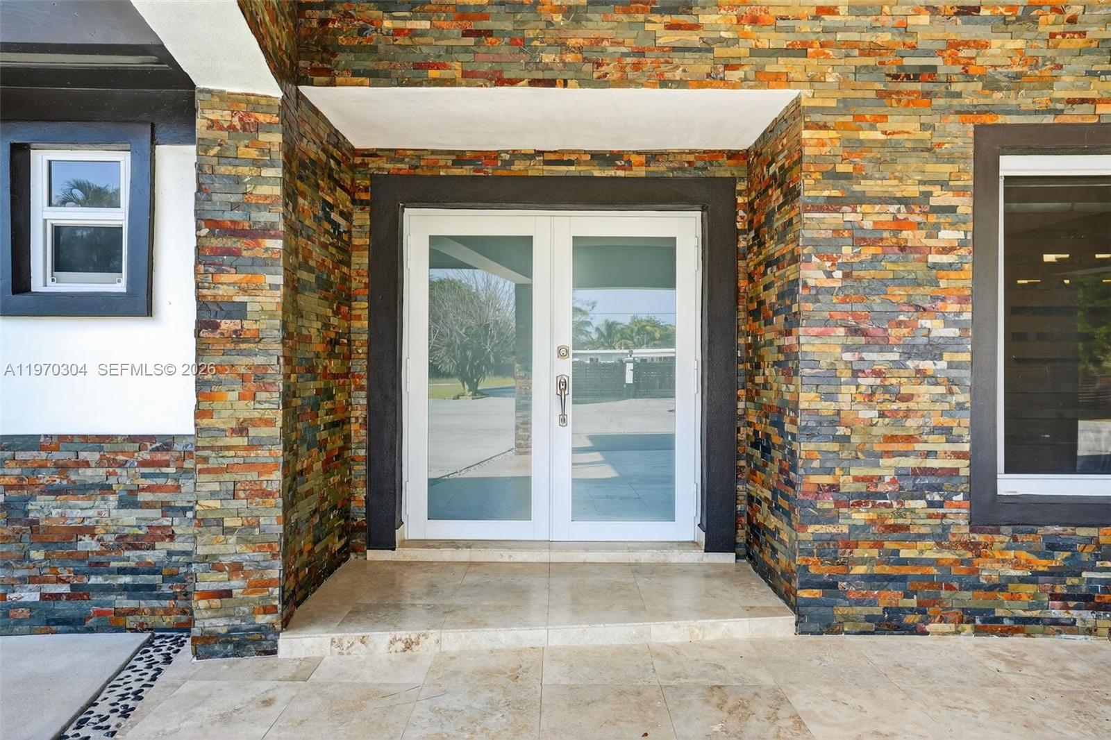 19390 Southwest 312th Street Homestead, FL 33030 - Photo 3 of 41 a front view of a house with a garage